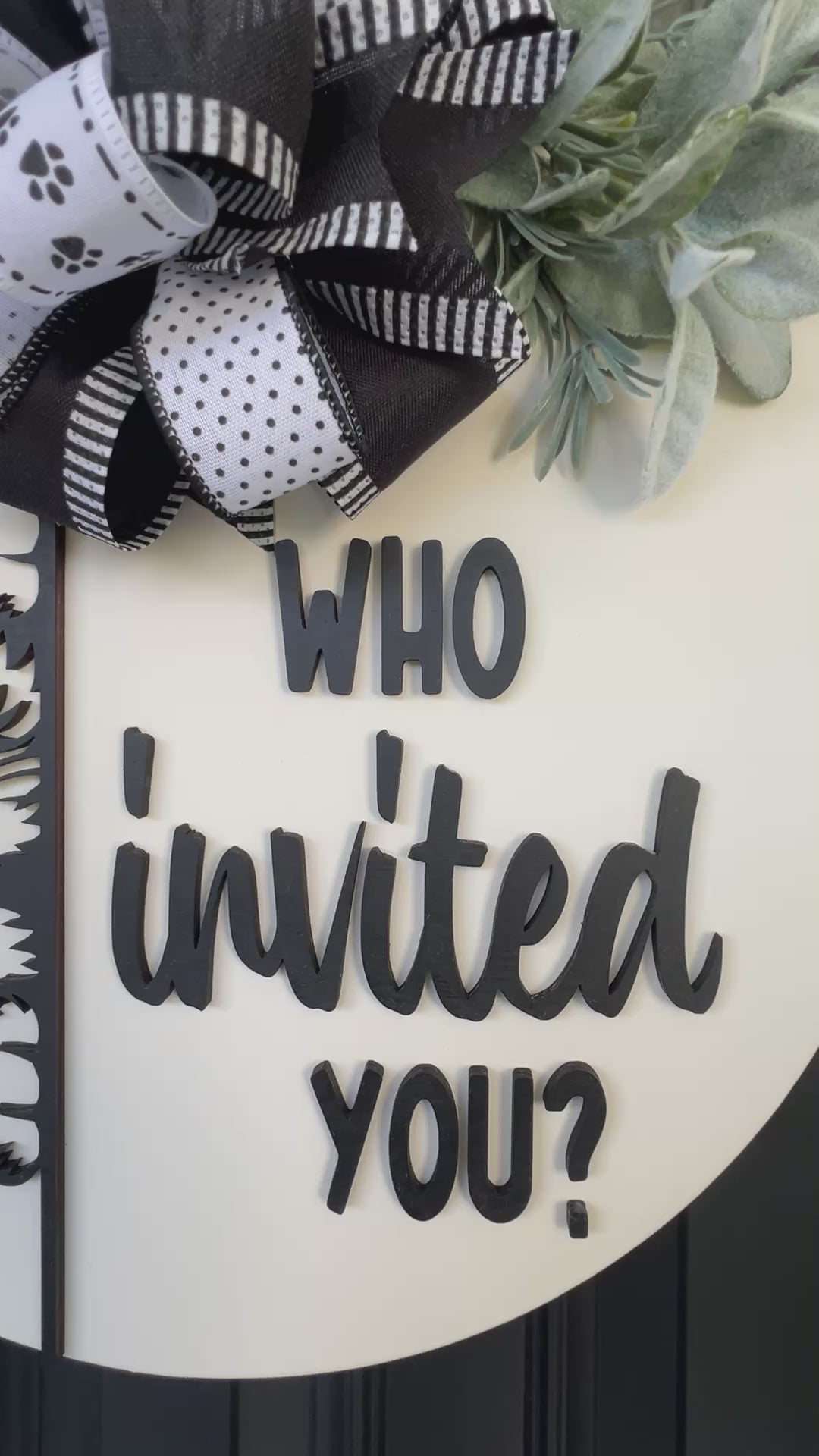 Funny cat door hanger featuring a black cat peeking around the edge and the phrase "Who Invited You?" displayed on a front door.