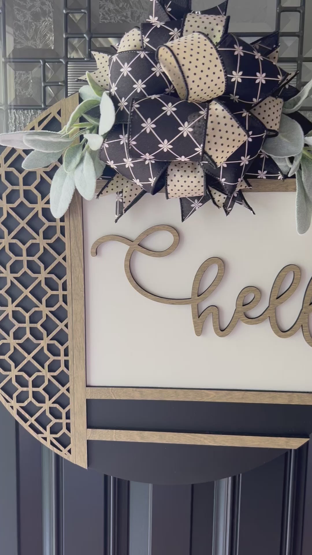 Modern farmhouse hello door hanger with raised wood lettering, neutral bow, and greenery on front door”