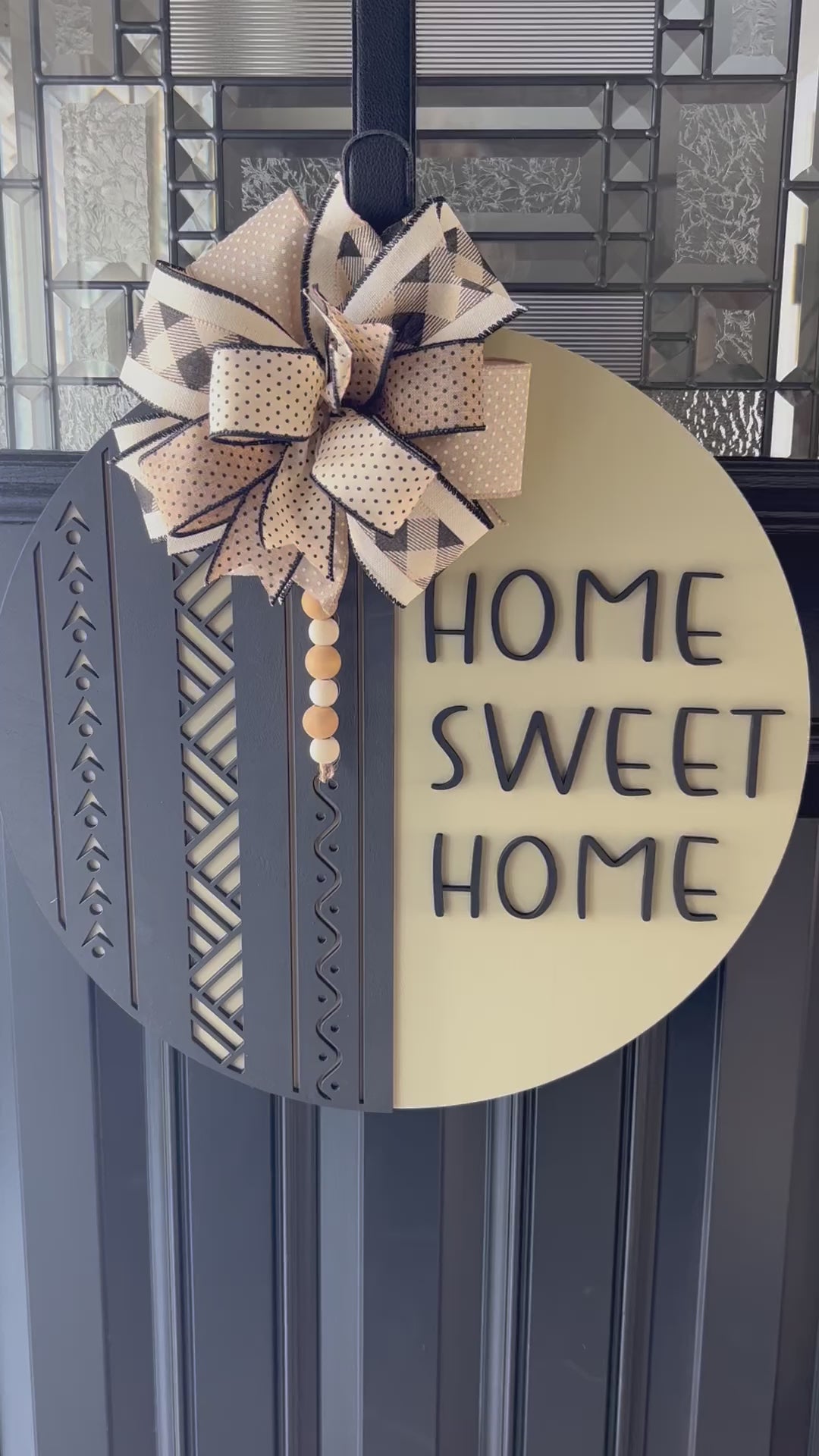 Home sweet home door hanger with neutral oatmeal color and black boho farmhouse design, handcrafted wooden front door decor- detailed close up 