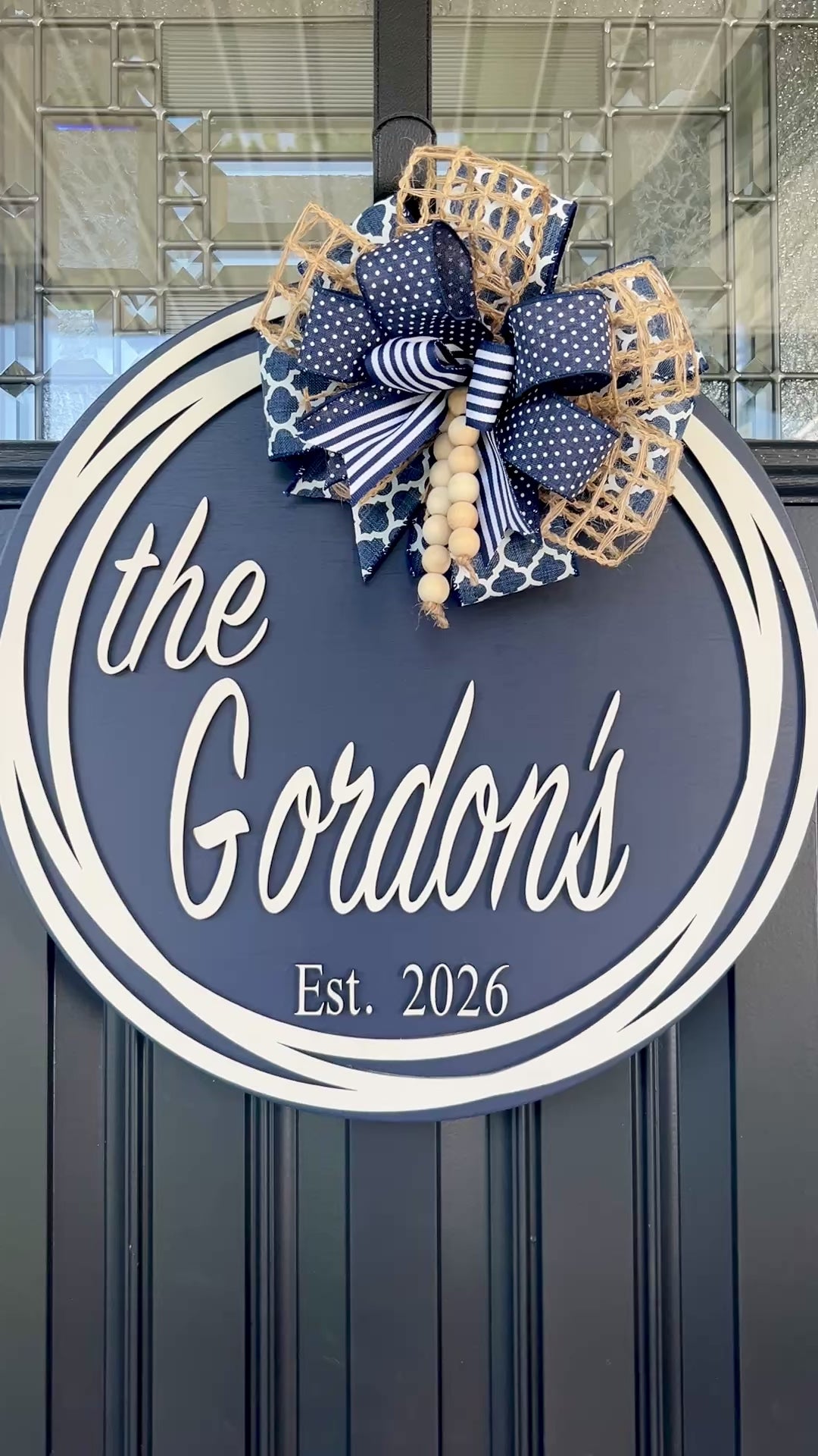 Round family name door hanger customized with last name and established date.